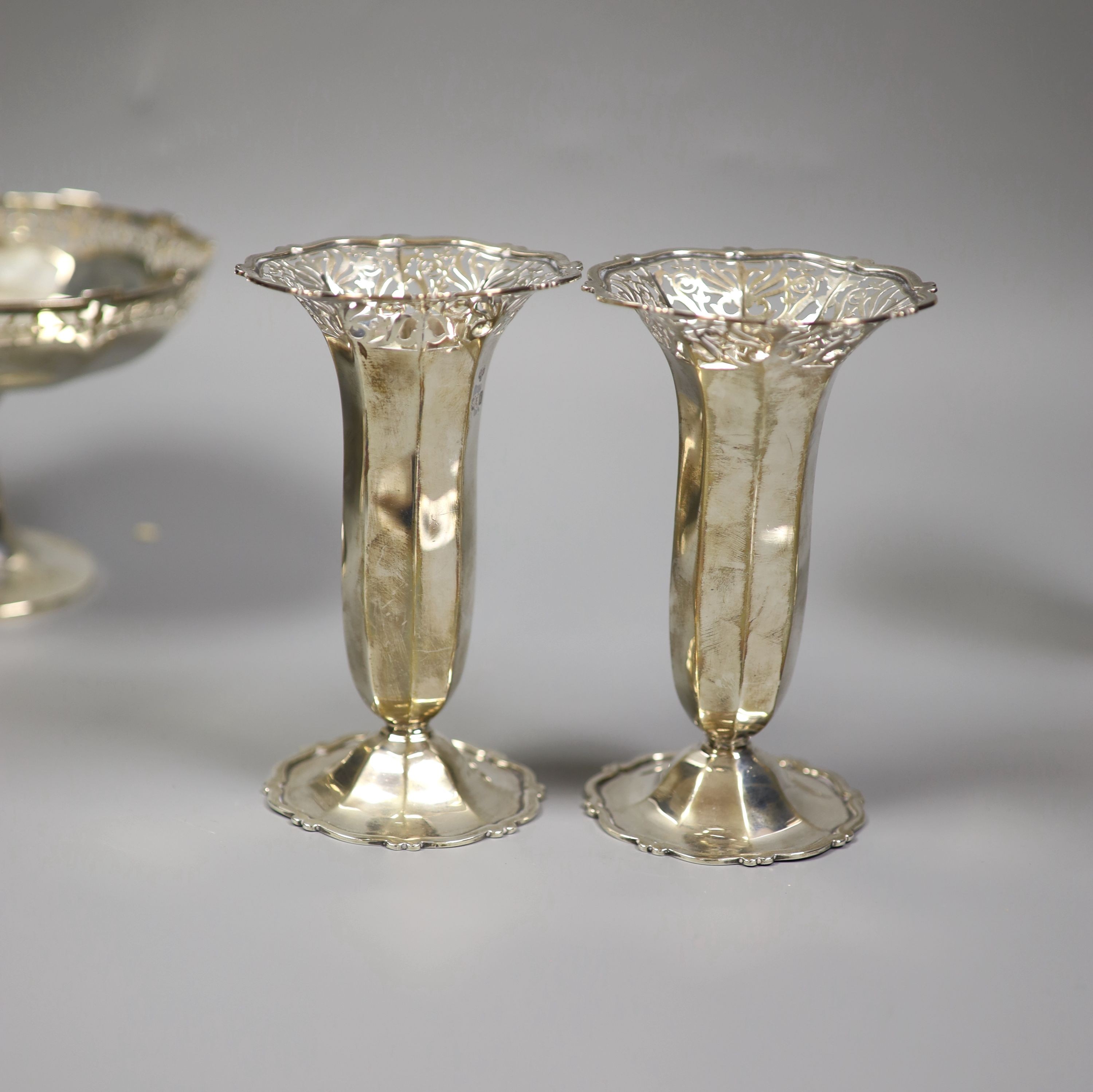 Two pairs Edwardian silver posy vases, London, 1901 and 1904, Goldsmiths & Silversmiths Co Ltd, together with a George V small pedestal bowl, Birmingham 1924 (mark rubbed) (5) total weight 24.0 ozt.